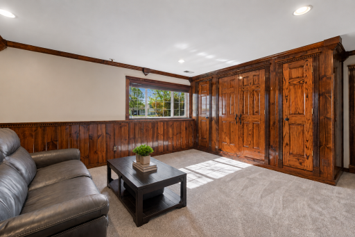 Spacious lower-level family room. The center doors open for a TV media system. Other doors are for additional storage. Brand new carpet in 2026!