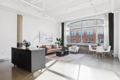 Enjoy 13' vaulted ceilings and soaring arched windows.