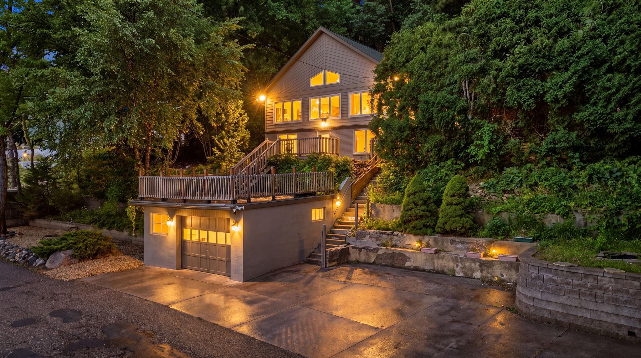 With approximately 185 feet of river frontage, step outside to the expansive two-tiered deck, perfect for hosting, dining al fresco, or simply soaking in the views, then head down to your private dock and boat landing.