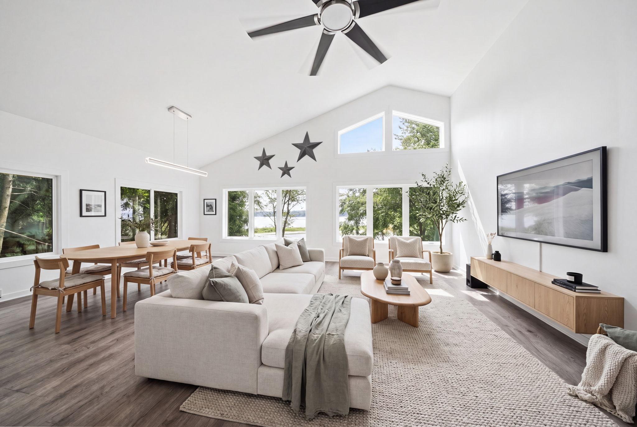 Inside, the open layout is enhanced by generous windows that flood the home with natural light and showcase breathtaking river views from nearly every room. (virtually staged)
