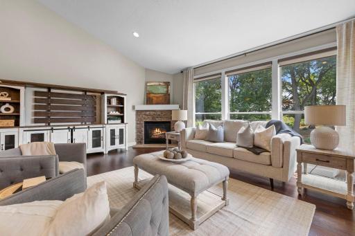 Living room featuring a stunning stone-surround fireplace.