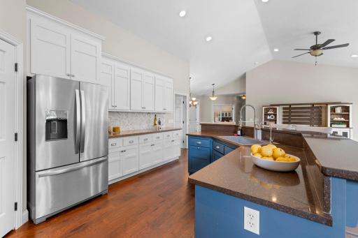 Spacious center island with breakfast bar seating, perfect for casual meals and gathering.