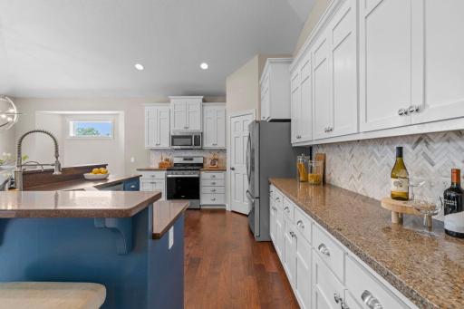 Plenty of cabinet storage pairs perfectly with granite countertops and a timeless tile backsplash.
