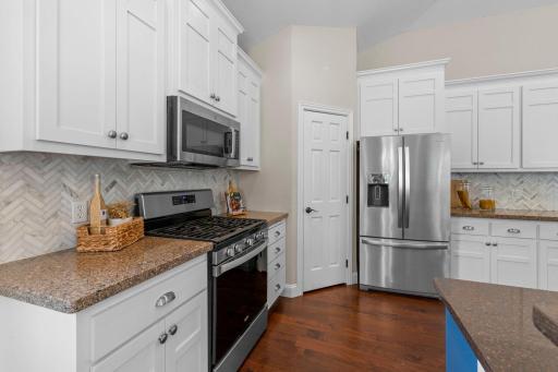 Stainless steel appliances highligted by a gas stove, in addtion to the spacious walk in pantry