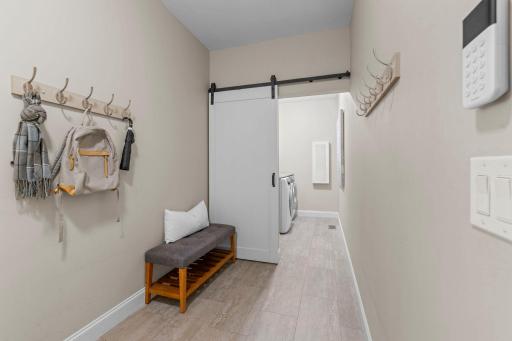 Mudroom with convenient access to the attached 3-car garage, laundry room, and kitchen.