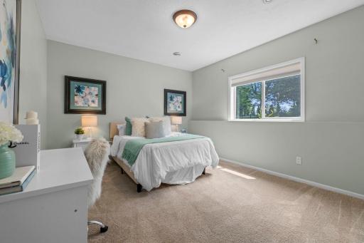 Third bedroom on the lower level with backyard views.