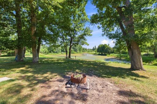 Pondside fire pit creates a cozy spot to unwind and enjoy the outdoors
