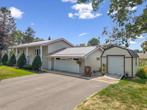 Two car attached garage plus storage shed