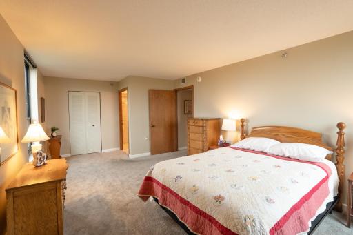 Large primary bedroom with walk in closet. Windows on 2 sides.