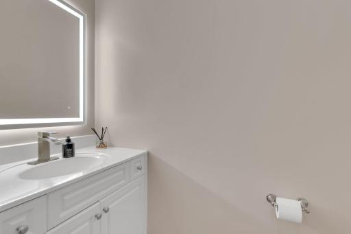 Main floor guest bathroom with new faucet and mirror.
