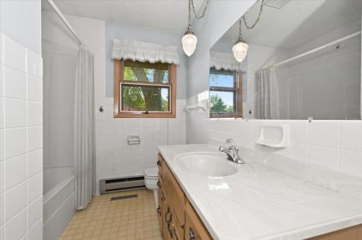 The large bathroom has a lot of storage, and is light and bright.