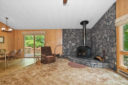 This open-concept living, dining and kitchen area has vaulted ceilings and a lot of space for entertaining and relaxing. The wood burning stove adds function and ambiance that we look for during our cold winters.