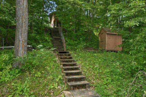 Roughly 25 steps leading down to the lake. Small shed for swimming and boating gear storage.
