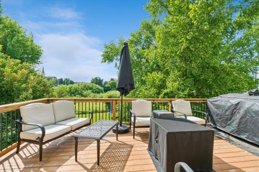 Step outside and enjoy your own backyard oasis. The expansive deck overlooks mature trees and tranquil wetlands, creating the perfect backdrop for morning coffee, evening sunsets, summer barbecues, or simply relaxing while enjoying nature.