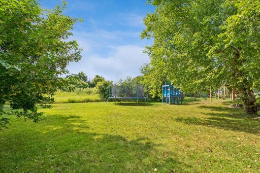 Step outside and enjoy your own backyard oasis. The expansive deck overlooks mature trees and tranquil wetlands, creating the perfect backdrop for morning coffee, evening sunsets, summer barbecues, or simply relaxing while enjoying nature.