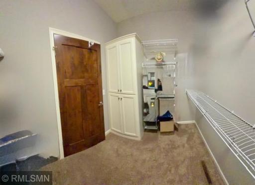 Huge Owner's walkin closet with shelving and cabinets.