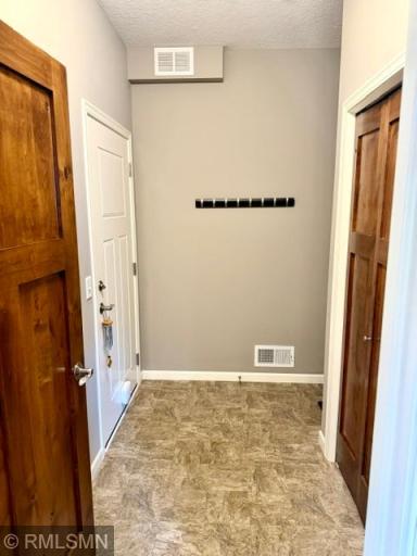 A mudroom entry from garage. NO steps for carrying in groceries directly to kitchen. Large double closet for storage, a bench and shelves.