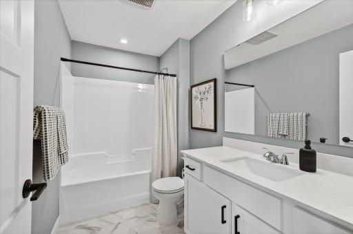 Upstairs full bathroom - photos are of a staged model home of the same floorplan. Selections and colors may differ.