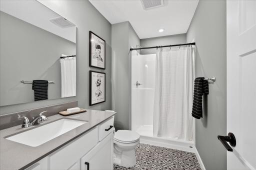 Lower level bathroom -photos are of a staged model home of the same floorplan. Selections and colors may differ.
