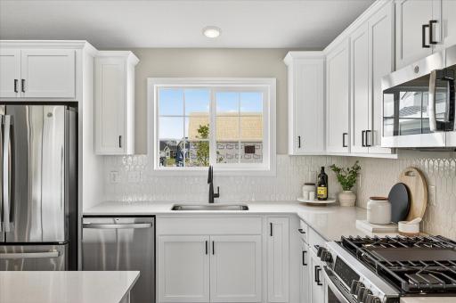 The beloved kitchen sink window! - photos are of a staged model home of the same floorplan. Selections and colors may differ.