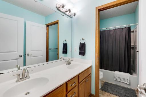 The upper-level full bathroom features a dual-entry layout with the vanity separated from the tub, shower, and toilet areaâproviding added privacy and convenience for busy mornings or multiple users.