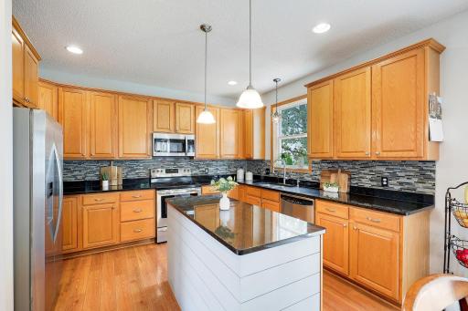 Spacious kitchen featuring granite countertops, abundant cabinetry, and generous counter spaceâperfect for everyday living and entertaining.