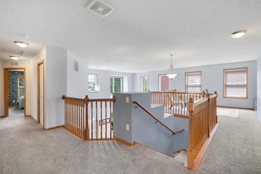 Natural light pours into the upper level through expansive windows, creating a bright and airy space you'll enjoy all day long.