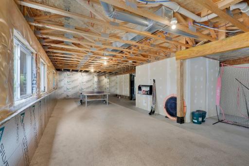 Ready for your vision, the unfinished lower level provides ample opportunity for future expansion. Featuring a bathroom rough-in and full egress windows for additional bedrooms, it's the perfect blank canvas for creating additional living space.