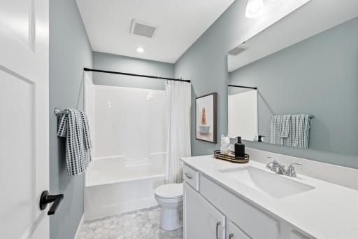 Main floor full bath - photos of a staged, completed model, of the same floorplan for illustrative purposes.