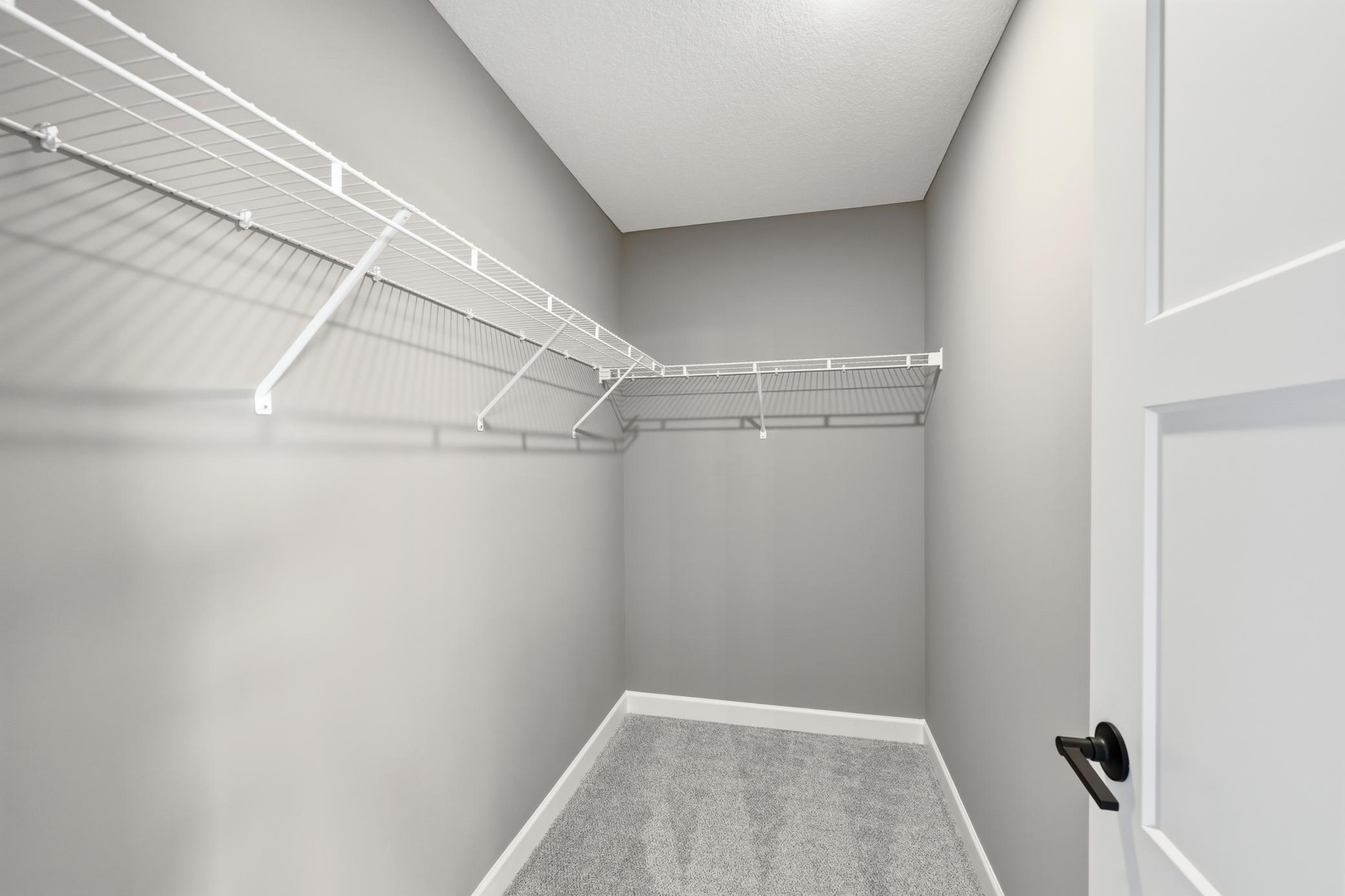 Walk-in closet - photos of a staged, completed model, of the same floorplan for illustrative purposes.