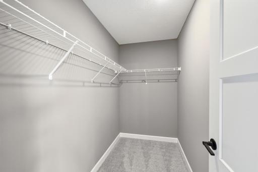 Walk-in closet - photos of a staged, completed model, of the same floorplan for illustrative purposes.