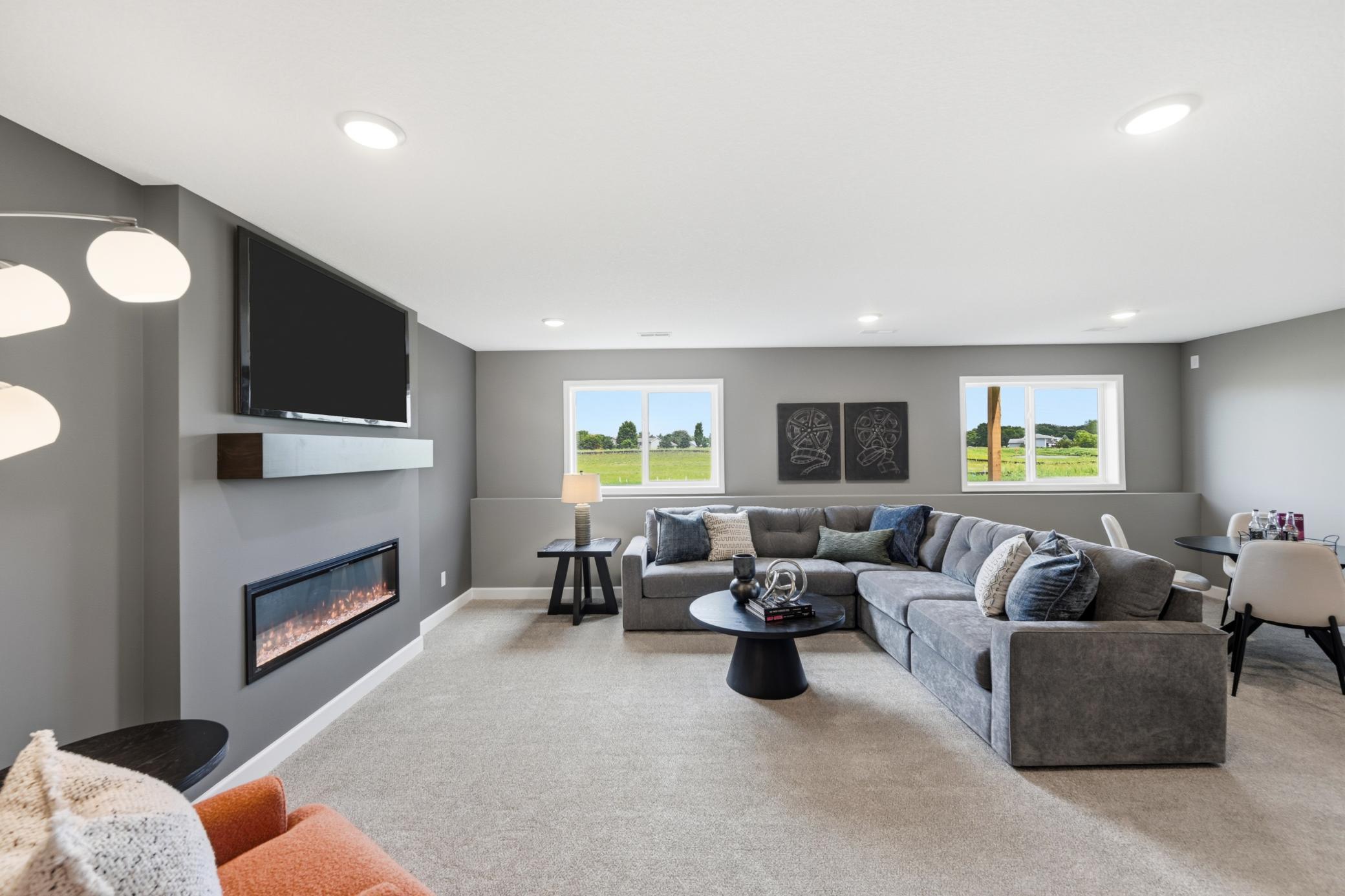 Lower level family room - photos of a staged, completed model, of the same floorplan for illustrative purposes.