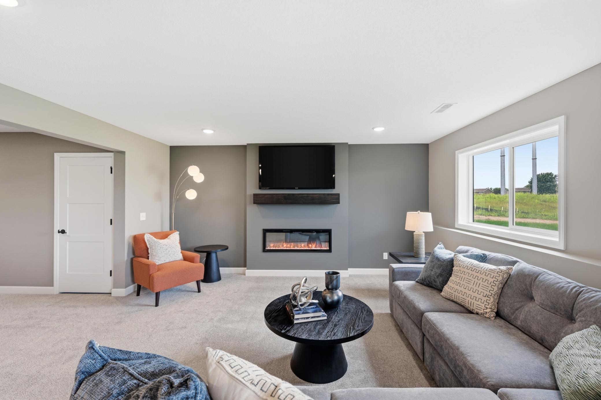 Lower level family room - photos of a staged, completed model, of the same floorplan for illustrative purposes.