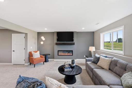 Lower level family room - photos of a staged, completed model, of the same floorplan for illustrative purposes.