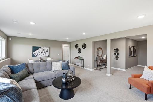 Lower level family room - photos of a staged, completed model, of the same floorplan for illustrative purposes.