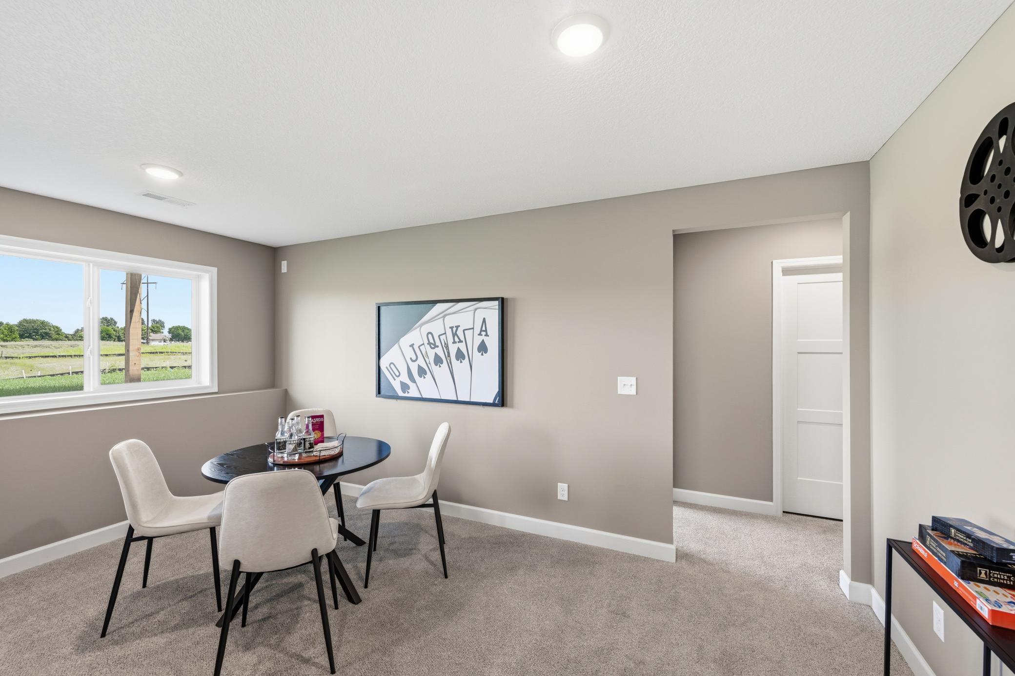 Lower level family room - photos of a staged, completed model, of the same floorplan for illustrative purposes.