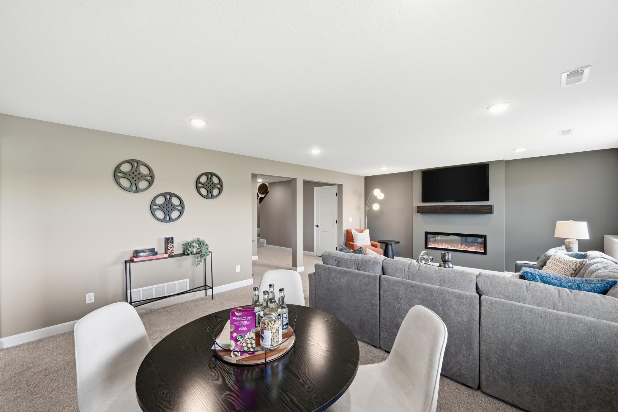 Lower level family room - photos of a staged, completed model, of the same floorplan for illustrative purposes.