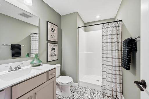 Lower level bathroom - photos of a staged, completed model, of the same floorplan for illustrative purposes.