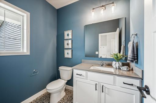 Main floor powder room - photo is of a staged model home of the same floorplan. Selections and colors may differ.