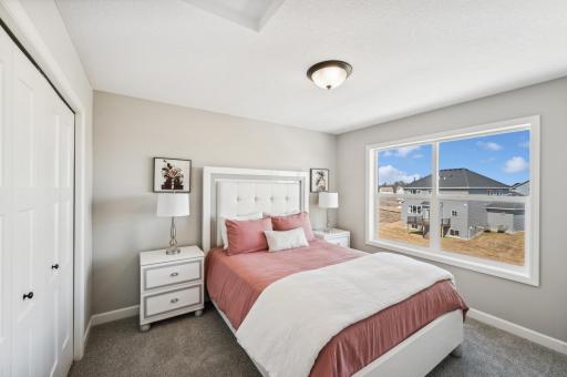 Bedroom 2 - photo is of a staged model home of the same floorplan. Selections and colors may differ.
