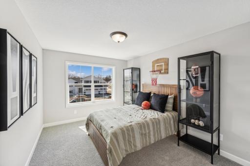 Bedroom 3 - photo is of a staged model home of the same floorplan. Selections and colors may differ.