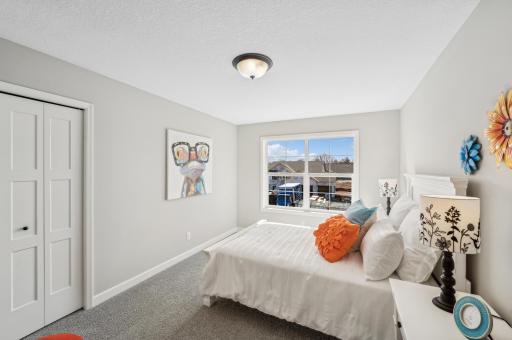 Bedroom 4 - photo is of a staged model home of the same floorplan. Selections and colors may differ.