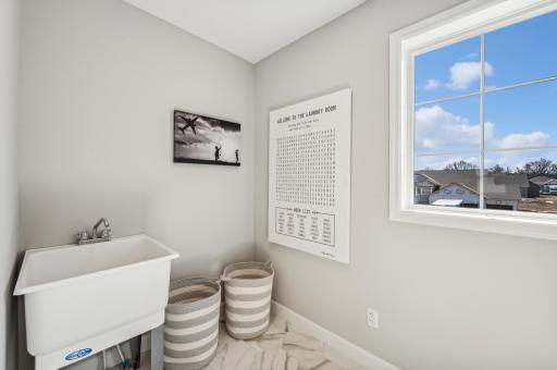 Laundry room - photo is of a staged model home of the same floorplan. Selections and colors may differ.