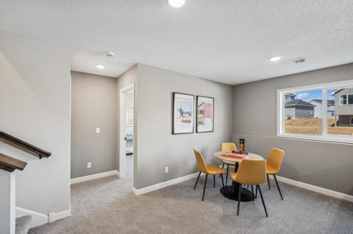 Finished lower level family room - photo is of a staged model home of the same floorplan. Selections and colors may differ.