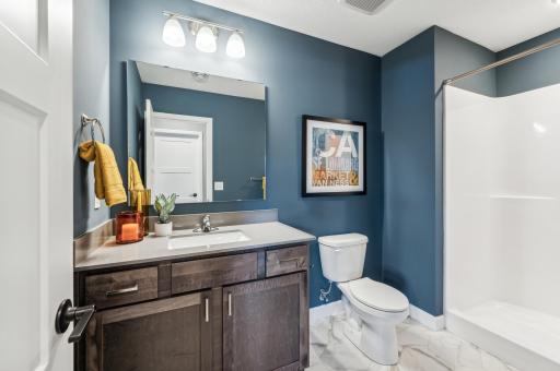 Lower level bathroom - photo is of a staged model home of the same floorplan. Selections and colors may differ.
