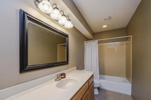 This FULL lower level bath with tile flooring provides options for guests.