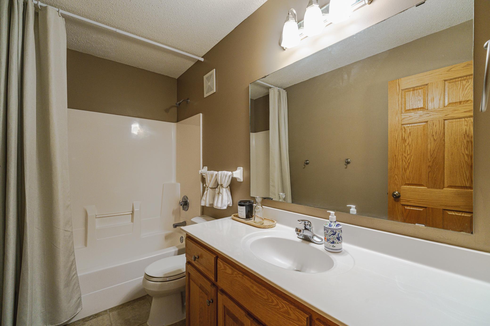 This full bath with tile flooring lies off the main hall.