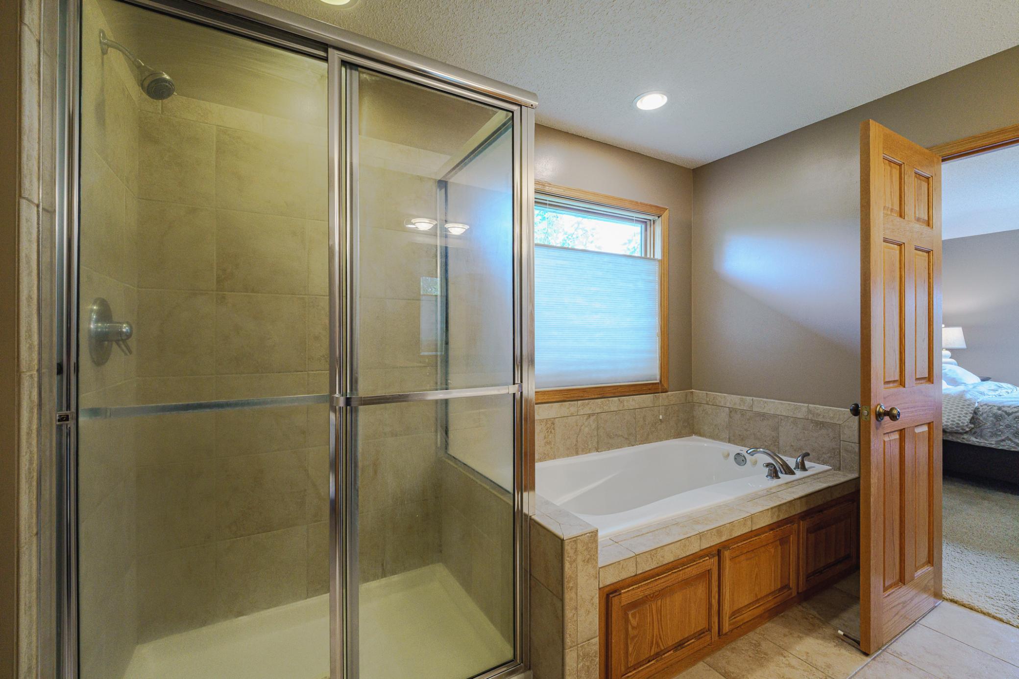 The primary suite also has receives lots of natural light and has a private commode and a walk-in closet.