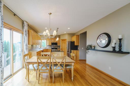 The kitchen opens to a spacious dining area that leads to the backyard via a composite deck.