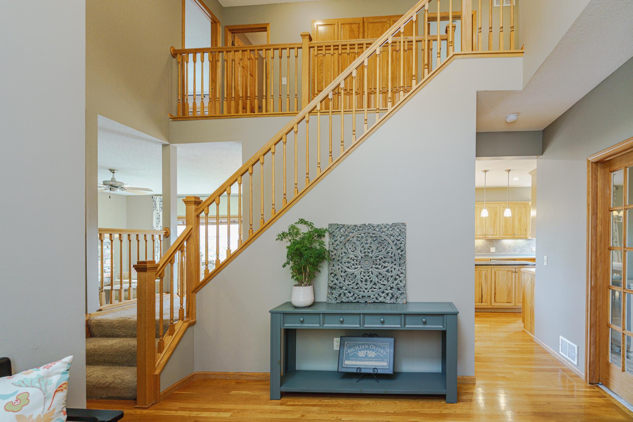 The foyer also has a dual-access open staircase to the second floor.